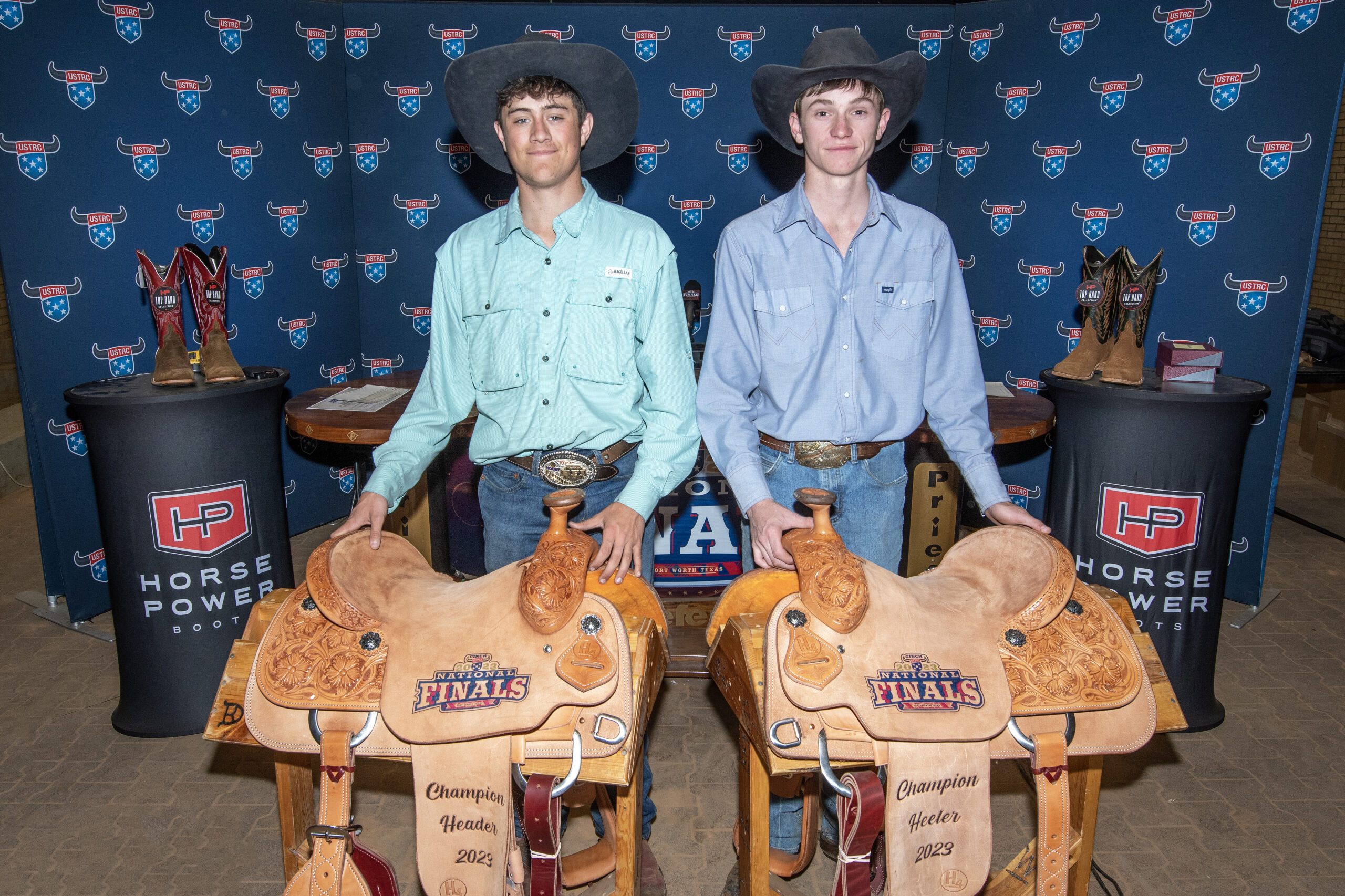 Winners of the Total Feeds #11.5 Shootout, Levi James and Garrett Hughes, with their trophy saddles.