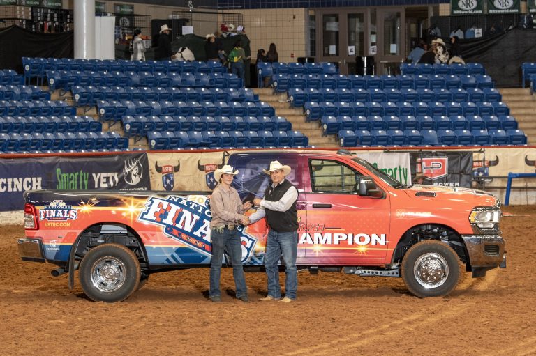 Zane Starns pictured with the Ram dually he won in the #9.5 Ram Truck Roping.