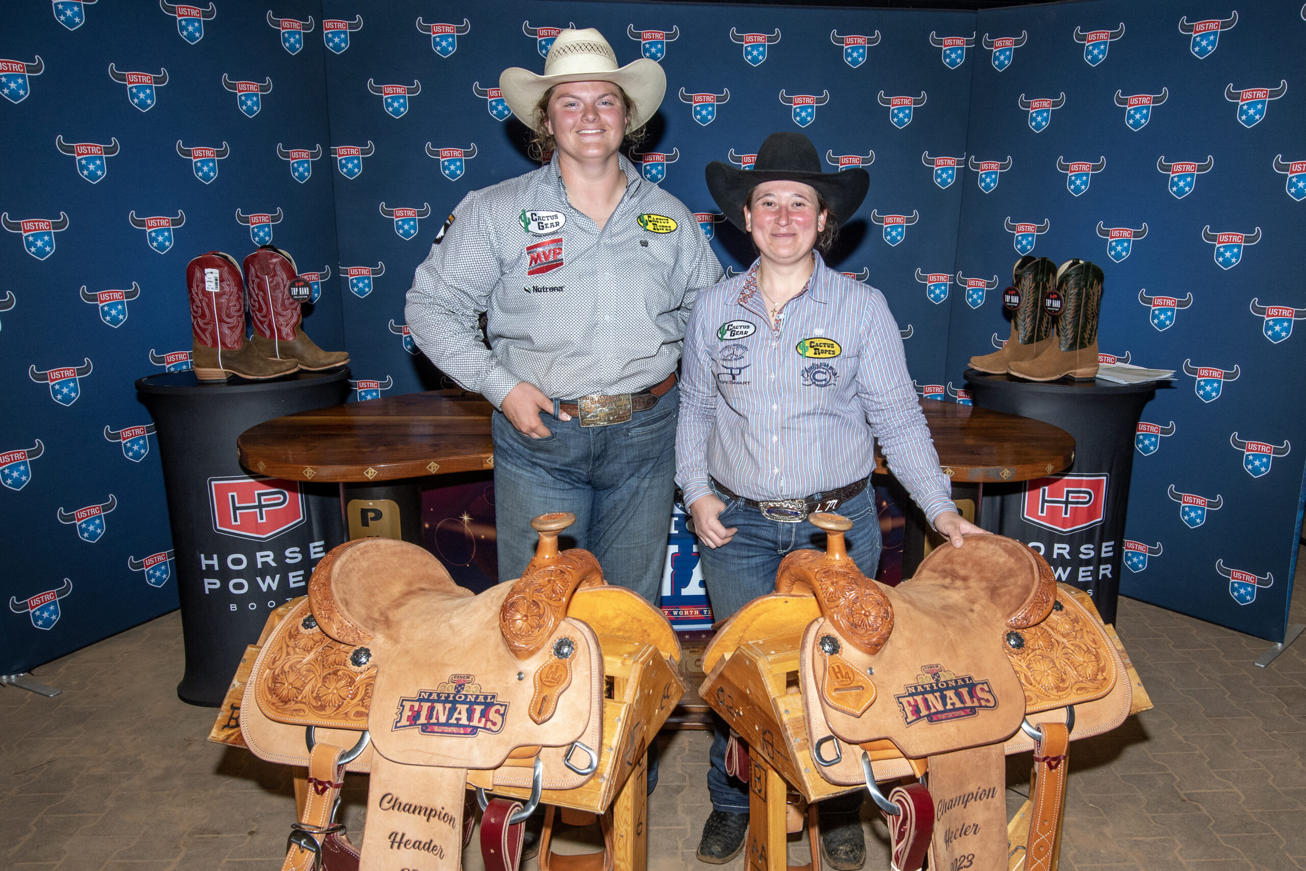 Bailey Gubert and Lorraine Moreno pose with their saddles after winning the Cinch Ladies Open.