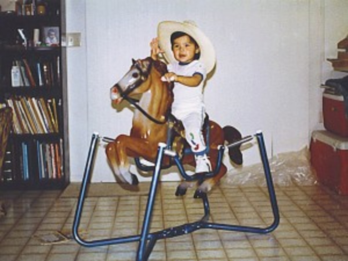Baby Erich Rogers riding a bouncy horse.